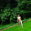 Cute girl from Japan takes off her sweater and runs in the grass naked with her trimmed hairy beaver exposed