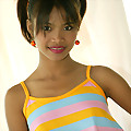 Adorable pigtail Thai teen shows off her colorful dress and pretty white panties